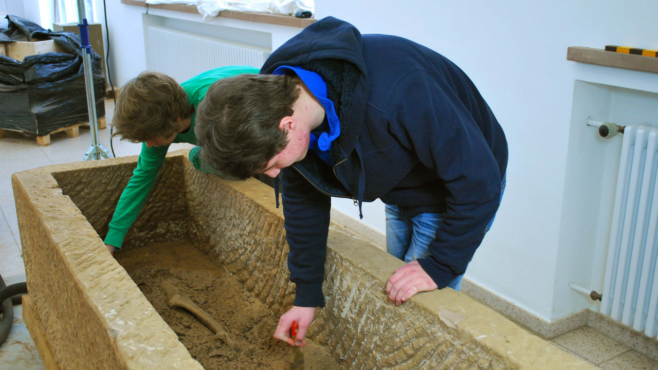 Archäologenarbeit im Winter: Freilegen des Inhalts eines Sarkophags von der Moselschleuse 